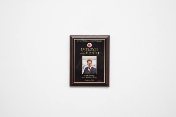 A framed plaque on a white wall