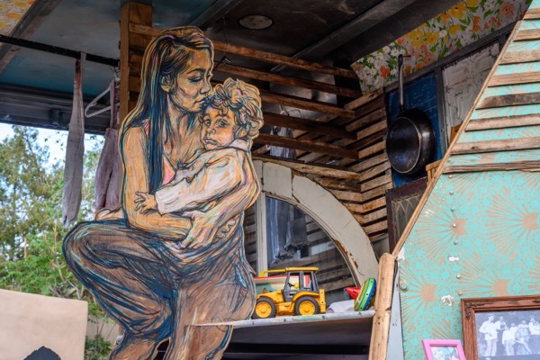 A painted mother and child on a wall inside the sculpture