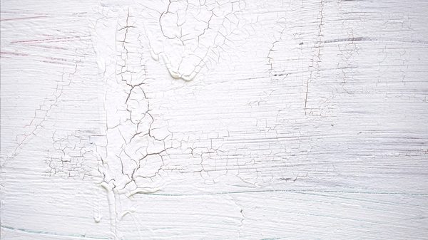 No. 5 HOWARD STREET, NEW YORK NEW YORK 10013: a close-up of thick, cracked white paint on a weathered surface