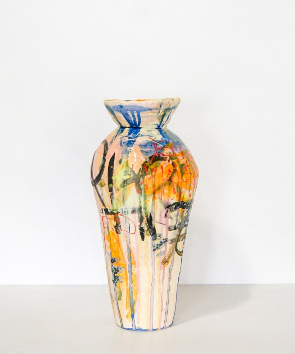 So Tired by Pauly Maloney: a tall stoneware vase covered in loose drips and marks of blue, orange, yellow and black glaze over a cream ground