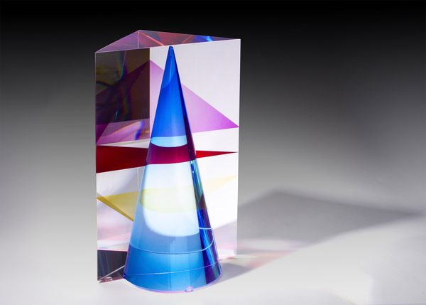 Cathedral of Color by Pavel Novak: a clear glass prism holding a blue cone and planes of red and yellow, on a grey background