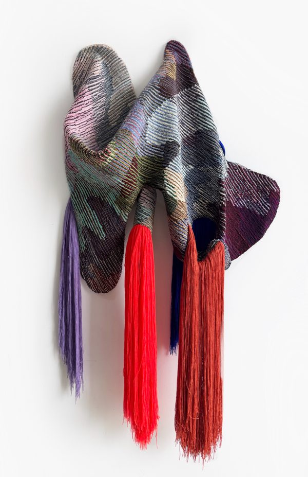 Dissolving Time by Vanessa Valero: a hanging textile of woven panels in grey, lilac and violet with long red and purple fringes